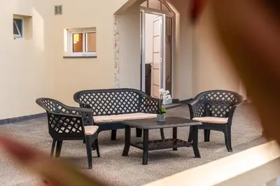 a patio with three chairs and a table at Casa Estrela Dos Reis in Estreito da Calheta