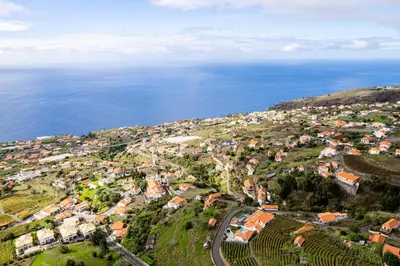 an aerial view of a town next to the ocean at Casa Estrela Dos Reis in Estreito da Calheta