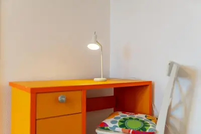 a orange desk with a lamp and a pillow at Campo & Mar Apartments in Porto Moniz