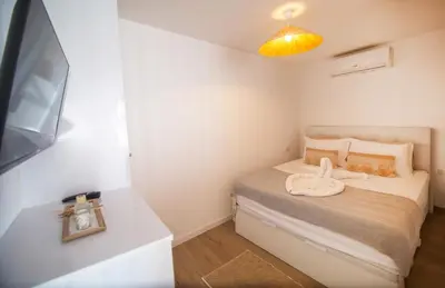 a small bedroom with a bed and a yellow light at Wave Shadows Beach House Oceanfront property - Bottom Floor in Paul do Mar