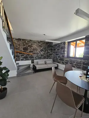a living room with a couch and a table at Quinta das Rosas 6 Amaizing Seaview Trekking Beach in Estreito da Calheta