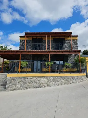 a large building with a balcony with chairs on it at Quinta das Rosas 6 Amaizing Seaview Trekking Beach in Estreito da Calheta
