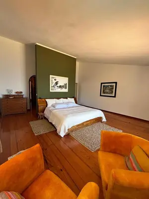 a bedroom with a bed and two couches at Suite Bela Vigia 2 in Jardim do Mar