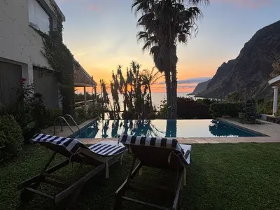 a view of the ocean at night with a ship in the water at Suite Bela Vigia 2 in Jardim do Mar