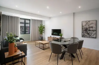 a living room with a table and chairs and a couch at Atlantic Blue 2 - central and with garage in Funchal