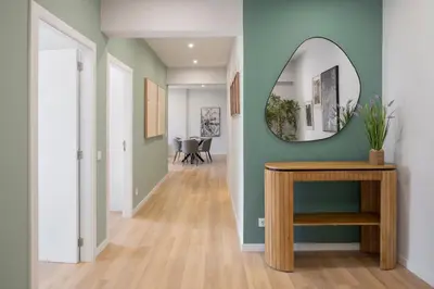 a hallway with a mirror and a table at Atlantic Blue 2 - central and with garage in Funchal