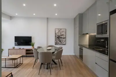 a kitchen and dining room with a table and chairs at Atlantic Blue 2 - central and with garage in Funchal