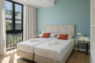 a bedroom with a large bed with a large window at Atlantic Blue 2 - central and with garage in Funchal