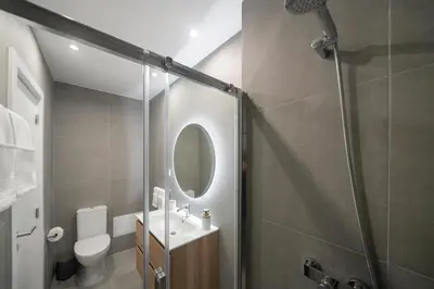 a bathroom with a shower and a toilet and a sink at Atlantic Blue 2 - central and with garage in Funchal