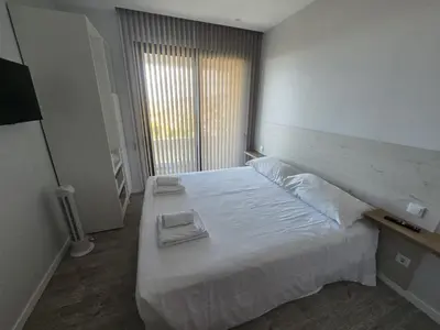 a bedroom with a large bed with two towels on it at Ocean Paradise de Santa Luzia in Funchal