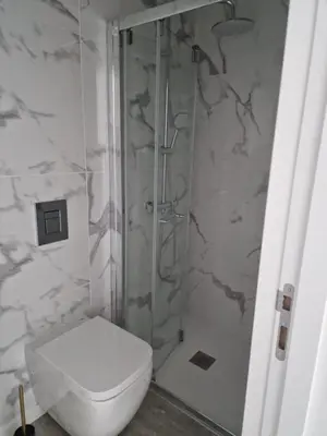 a bathroom with a toilet and a glass shower at Ocean Paradise de Santa Luzia in Funchal
