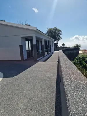 a building with a retaining wall in front of it at Ocean Paradise de Santa Luzia in Funchal