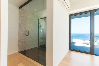 a glass shower in a room with a window at Majestic Penthouse View by Atlantic Holiday in Funchal