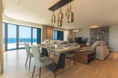 a dining room and living room with a table and chairs at Majestic Penthouse View by Atlantic Holiday in Funchal