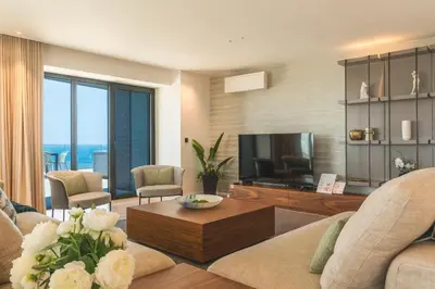 a living room with a couch and a television at Majestic Penthouse View by Atlantic Holiday in Funchal
