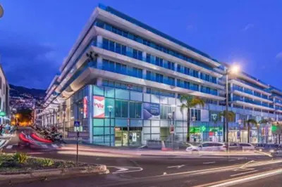 a large glass building with a street in front of it at La Vie Funchal - City Center & Free Park in Funchal