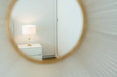 a mirror in a room with a lamp on a table at La Vie Funchal - City Center & Free Park in Funchal