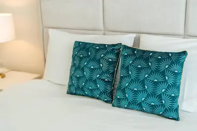 two blue pillows sitting on top of a bed at La Vie Funchal - City Center & Free Park in Funchal