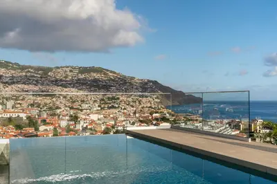 a swimming pool with a view of a city at Maravilhas II by An Island Apart in Funchal