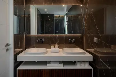 a bathroom with two sinks and a large mirror at Maravilhas II by An Island Apart in Funchal
