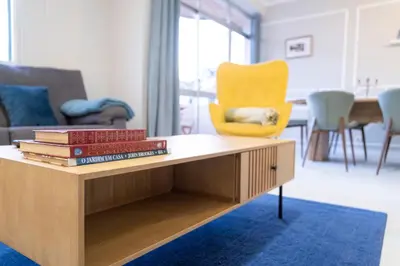 a coffee table with books on it in a living room at Lux City Center Apartment 2 in Funchal