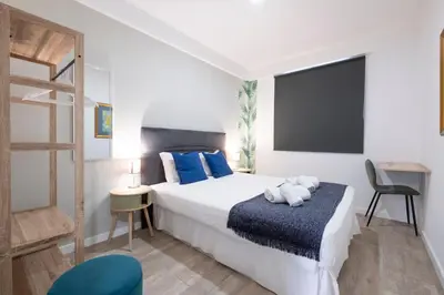 a bedroom with a bed with a teddy bear on it at Lux City Center Apartment 2 in Funchal