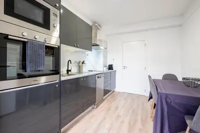 a kitchen with stainless steel appliances and a table at Lux City Center Apartment 2 in Funchal