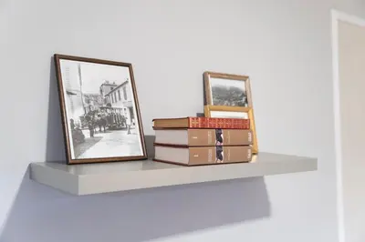 a shelf with books and a mirror on it at Lux City Center Apartment 2 in Funchal