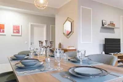 a dining room table with plates and glasses on it at Lux City Center Apartment 2 in Funchal