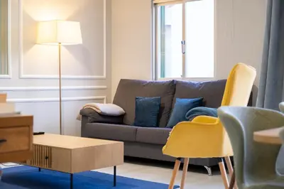 a living room with a couch and chairs at Lux City Center Apartment 2 in Funchal