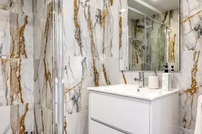 a bathroom with a white sink and a mirror at BSE15 Apartments 1B, a Home in Madeira in Funchal