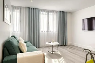a living room with a green couch and a table at BSE15 Apartments 1C, a Home in Madeira in Funchal