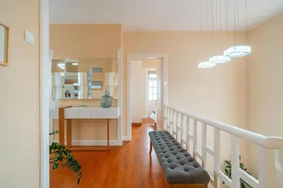 a room with a staircase with a bench and a sink at Villa Oasis Sea View - 3 Bedrooms in Funchal