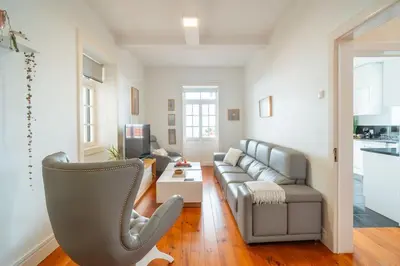 a living room with a couch and a chair at Villa Oasis Sea View - 3 Bedrooms in Funchal