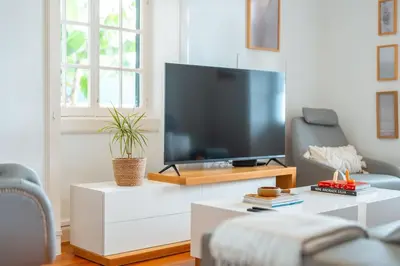 a living room with a large flat screen tv at Villa Oasis Sea View - 3 Bedrooms in Funchal