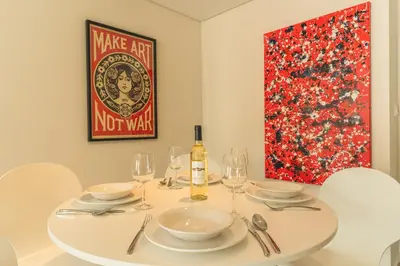 a white dining room table with a bottle of wine at Art Studio by Atlantic Holiday in Funchal