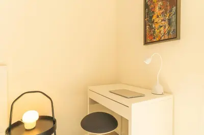 a white desk with a lamp and a laptop on it at Art Studio by Atlantic Holiday in Funchal