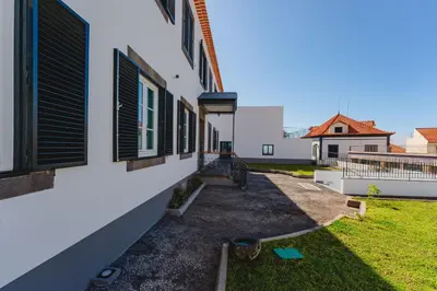 a view of the side of a house with windows at FLH Funchal A Quinta do Conde in Funchal