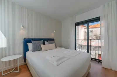 a bedroom with a large white bed and a window at FLH Funchal A Quinta do Conde in Funchal
