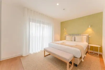 a bedroom with a large bed and a window at FLH Funchal A Quinta do Conde in Funchal