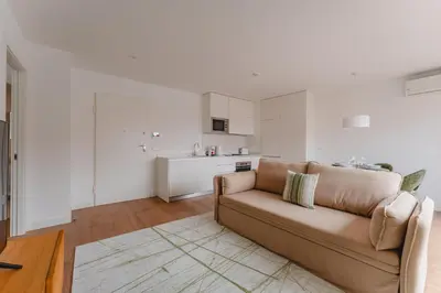 a living room with a couch and a kitchen at FLH Funchal A Quinta do Conde in Funchal