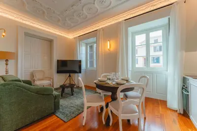 a living room with a green couch and a table at FLH Funchal A Quinta do Conde in Funchal