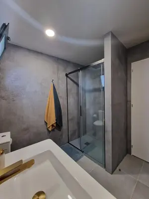 a bathroom with a shower and a tub at Favinha Rooftop in Machico