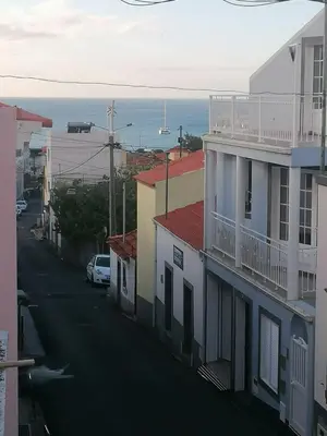 a city street with buildings and the ocean in the background at Favinha Rooftop in Machico