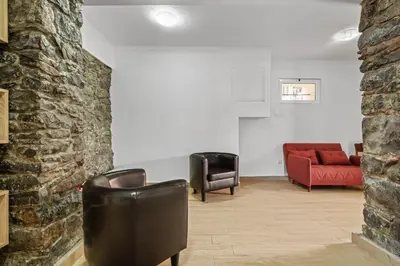 a living room with two chairs and a red couch at Casa da Avó Paraíso in Machico