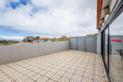 a balcony with a tile floor and a wall at Moniz Ocean Escape BBQ Near Porto Moniz Pools in Porto Moniz