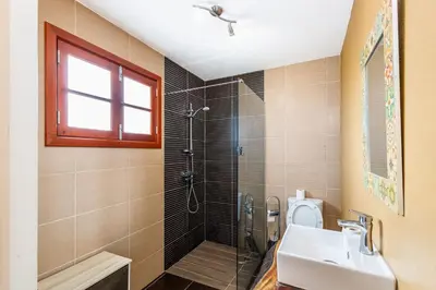 a bathroom with a shower and a sink and a toilet at Moniz Ocean Escape BBQ Near Porto Moniz Pools in Porto Moniz