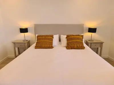 a bedroom with a white bed with two lamps at Step To The Sea 4, by Pausa Holiday Rentals in Funchal