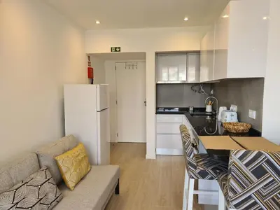 a kitchen and living room with a couch and a table at Step To The Sea 4, by Pausa Holiday Rentals in Funchal