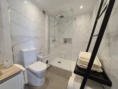 a white bathroom with a toilet and a shower at Step To The Sea 4, by Pausa Holiday Rentals in Funchal